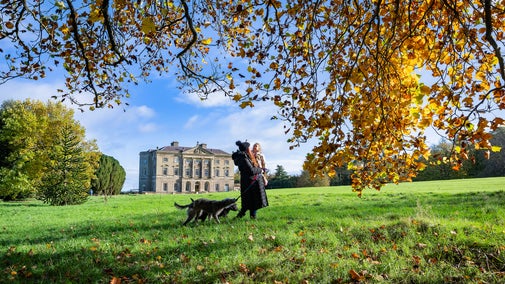 Family Walking Dog in-front of house